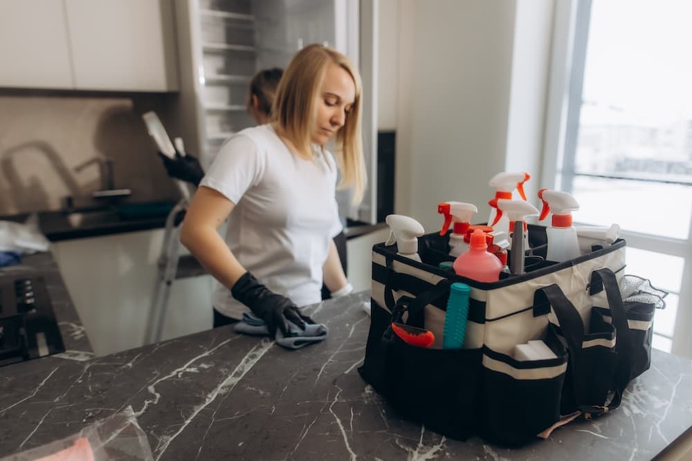 Professional cleaners wiping down kitchen surfaces