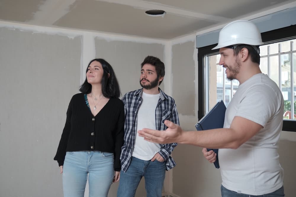 Young adults planning renovation with construction