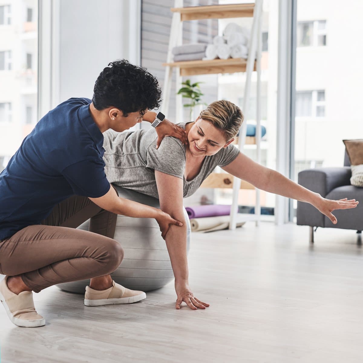 A physiotherapist guiding a client through a movement assessment.