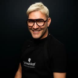Jody Ciplinski, smiling to camera in a salon apron.